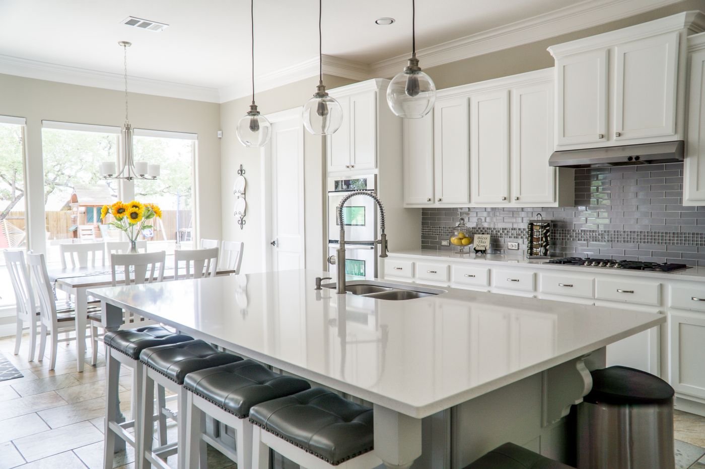 Modular kitchen installed during a Delhi NCR home construction project with island counter and pendant lighting