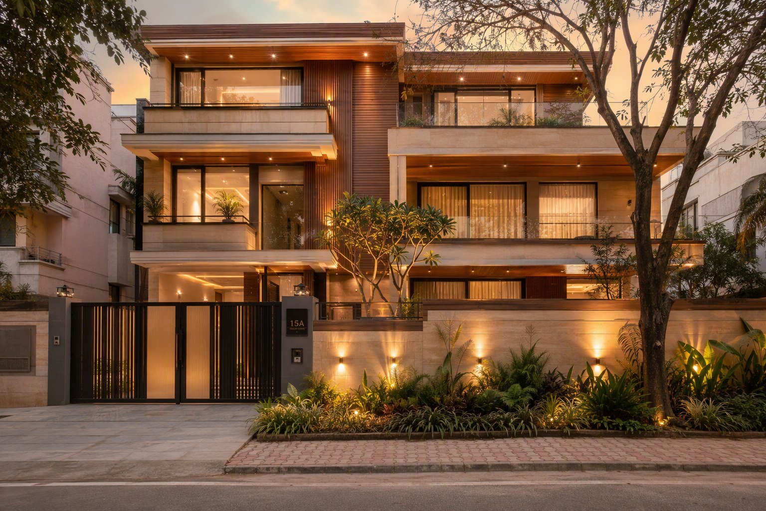 Renovated luxury home in DLF Phase 3 Gurugram at dusk with sandstone and teak facade and warm interior lighting